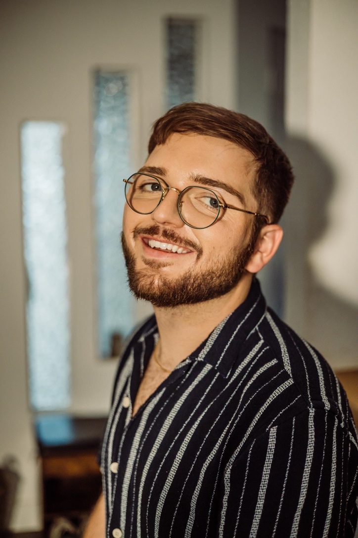 Devin Blackburn, smiling in warm natural light